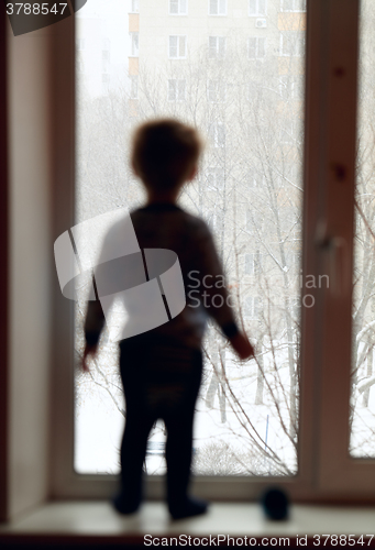 Image of Boy is looking through the window.