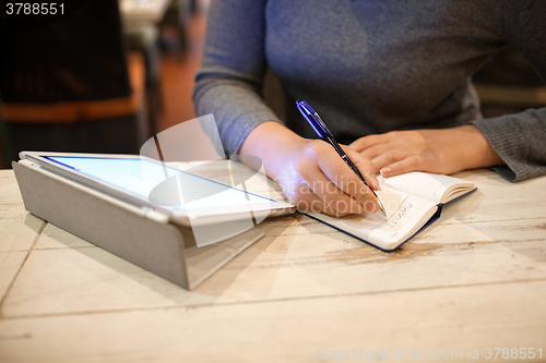 Image of Woman taking down information in notebook