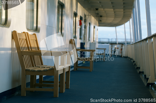 Image of Wooden chairs on the deck of cruise liner