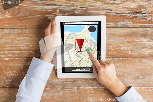 Image of close up of hands with navigator map on tablet pc