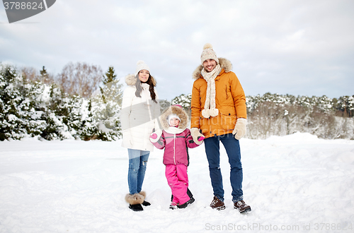 Image of happy family with child in winter clothes outdoors