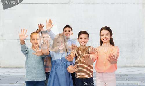 Image of happy children waving hands