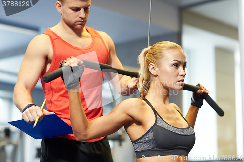 Image of man and woman flexing muscles on gym machine