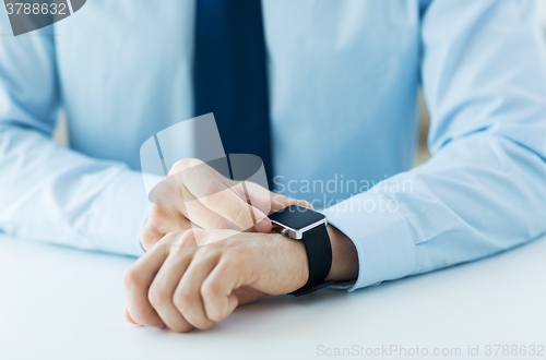 Image of close up of male hands setting smart watch