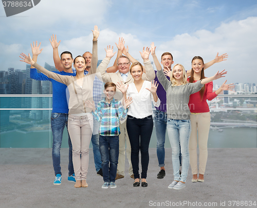 Image of group of smiling people waving hands