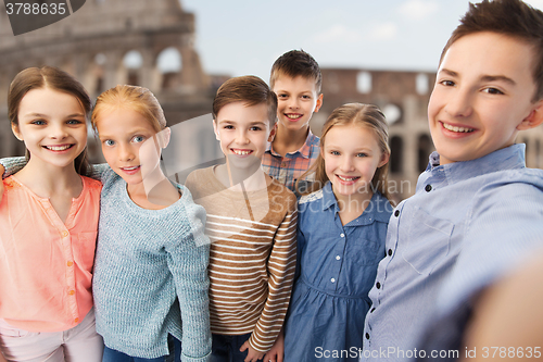 Image of children talking selfie over coliseum in rome