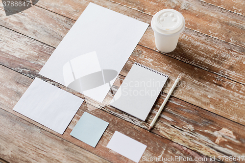 Image of close up of notebook, coffee cup and papers