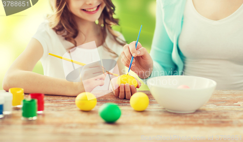 Image of close up of family coloring easter eggs