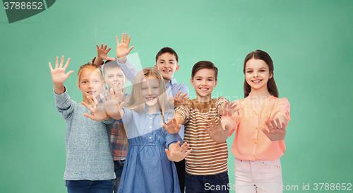 Image of happy children waving hands