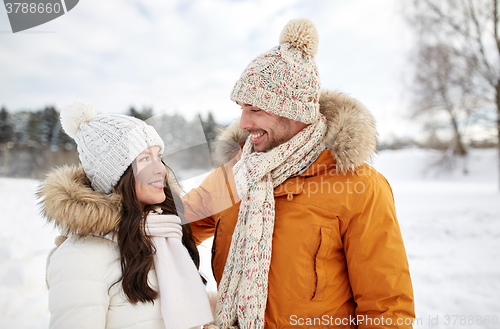 Image of happy couple walking over winter background