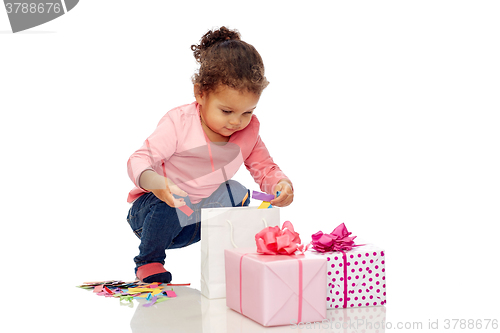 Image of happy little baby girl with birthday presents