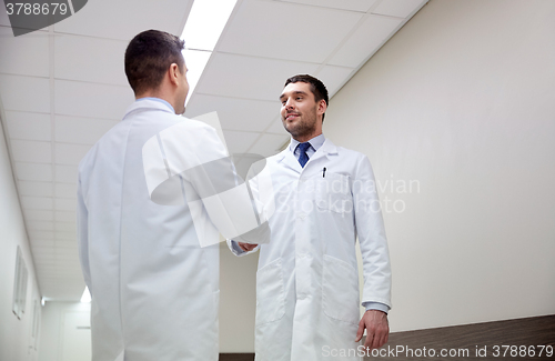 Image of smiling doctors at hospital doing handshake