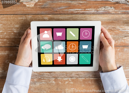 Image of close up of hands with applications on tablet pc