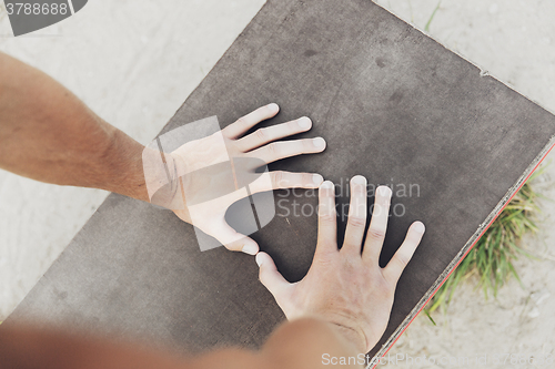 Image of close up of man hands exercising on bench outdoors
