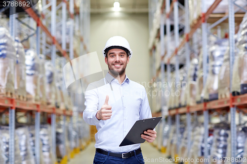 Image of happy man at warehouse showing thumbs up gesture