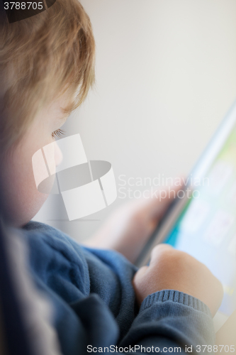 Image of Young boy using smart tablet