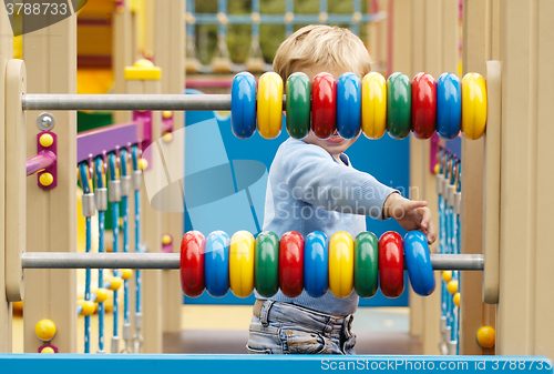 Image of Little boy playing with an abacus