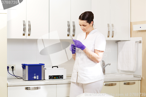 Image of Cosmetician preapring tools for sterilization