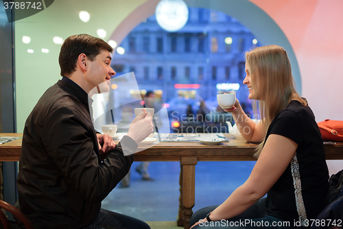 Image of Man and woman chatting over coffee