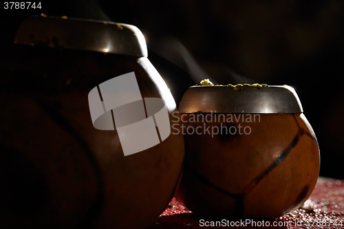 Image of Two yerba mate calabashes with smoke.