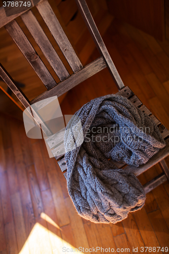 Image of Woollen scarf lying on wooden chair