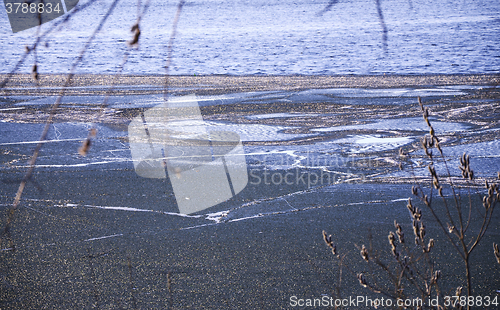 Image of Nature background with spring landscape and melting ice at the l