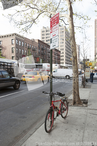 Image of Bike tied to pole in New York