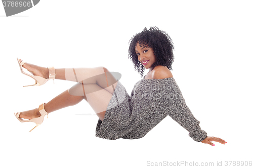 Image of African American woman sitting on floor.