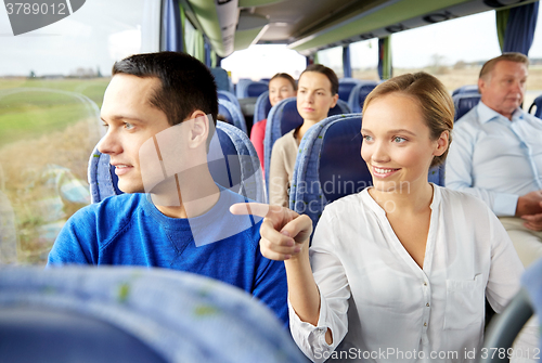 Image of happy couple or passengers in travel bus