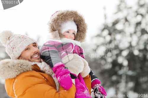 Image of happy family in winter clothes outdoors
