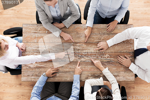 Image of close up of business team sitting at table