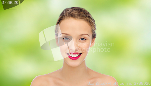 Image of smiling young woman face and shoulders