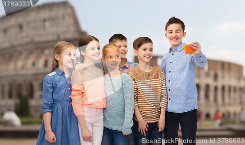 Image of happy children talking selfie by smartphone