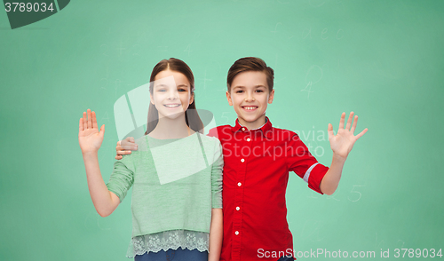 Image of happy boy and girl waving hand