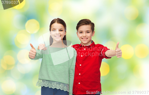 Image of happy boy and girl showing thumbs up