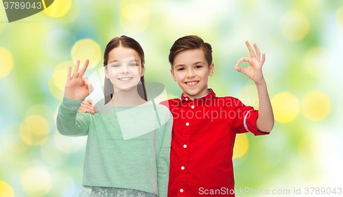 Image of happy boy and girl showing ok hand sign