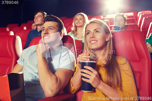 Image of happy friends watching movie in theater