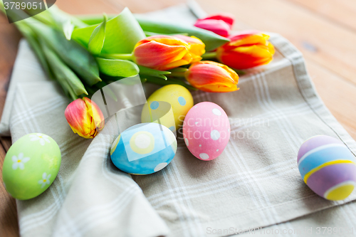 Image of close up of colored easter eggs and flowers