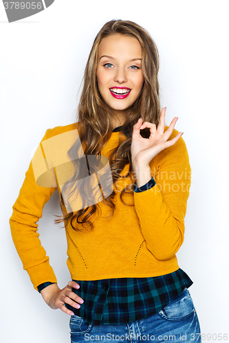 Image of happy young woman or teen showing ok hand sign