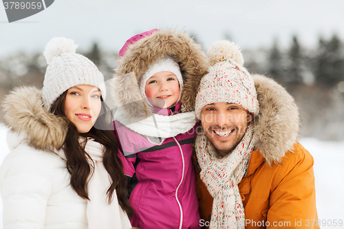 Image of happy family with child in winter clothes outdoors