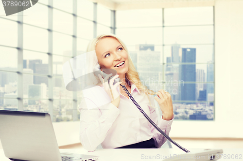 Image of smiling businesswoman calling on telephone