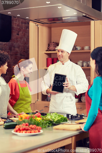 Image of happy women with chef and tablet pc in kitchen