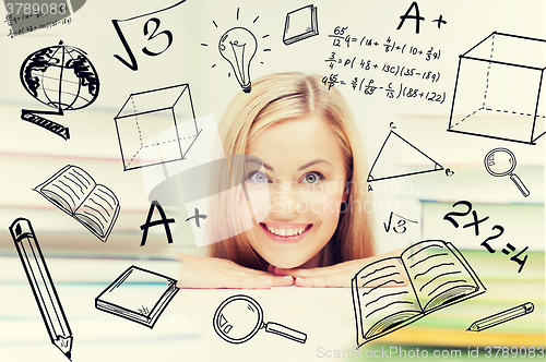 Image of student with stack of books and doodles