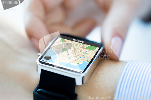 Image of close up of hands with map on smartwatch screen