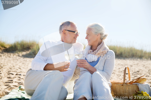 Image of happy senior couple talking on summer beach