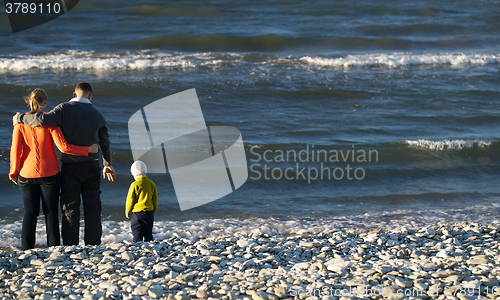 Image of Family of three on pebble beach