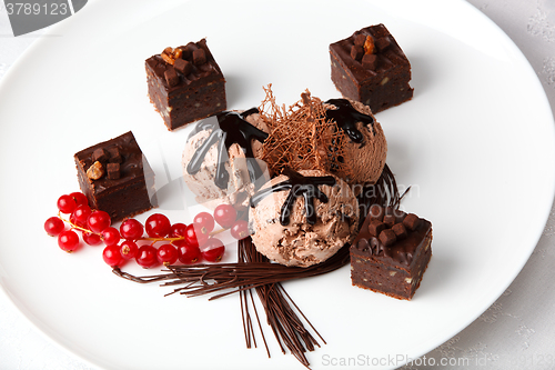 Image of Chocolate ice cream with bonbons and red currants