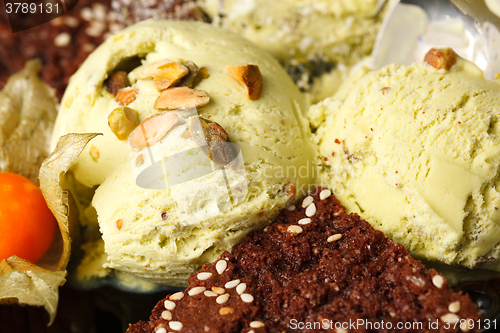 Image of Pistachio ice cream topped with nuts