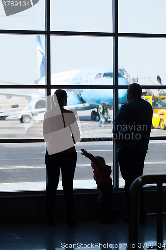 Image of Young family watching planes at an airport