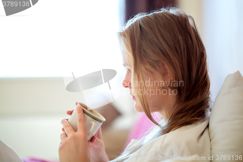 Image of Candid portrait of a woman drinking coffee